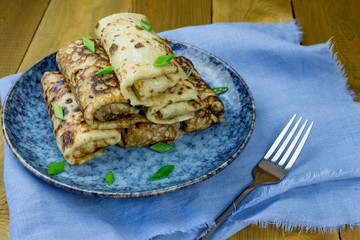 Homemade stuffed pancakes with meat, a Russian traditional dish. Close up. Pancake week. Pancake day.