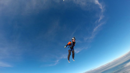 Fototapeta na wymiar Fitness. Skydiver engaged in air fitness. Man soars in the sky like a bird. Team of professionals.