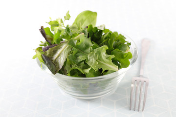 bowl of lettuce, green salad and fork