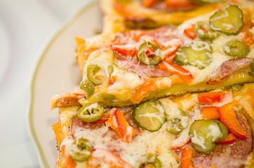 Homemade pizza on a white plate. Pizza made with your own hands. Homemade cake.