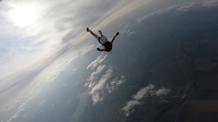 Fototapeta na wymiar Student. Man in professional equipment hovers in the air. Skydiver studies the sky.
