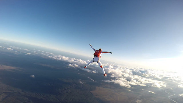 Student. Man in professional equipment hovers in the air. Skydiver studies the sky.