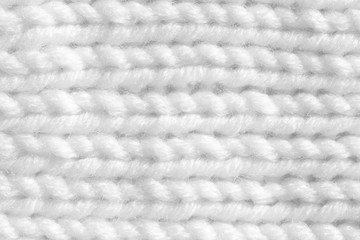 Handmade knitting texture, white background. Gray wool with fine threads, close-up.