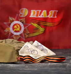 May 9 victory day holiday background. ribbon of St. George, soldier's war letter, military cap. 