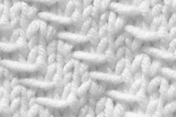 Handmade knitting texture, white background. Gray wool with fine threads, close-up.