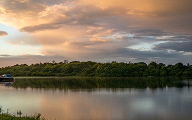 Orange sunset sky and reflection over an irish lake