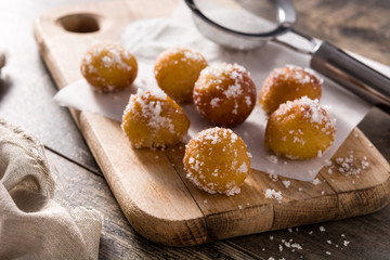 Carnival fritters or buñuelos de viento for holy week on wooden table