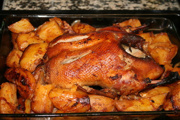 Duck in honey and stuffed with apples baked. And potatoes