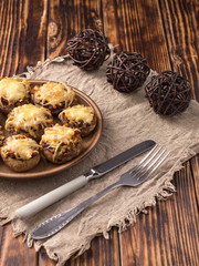 baked mushrooms with vegetables and cheese on a plate.