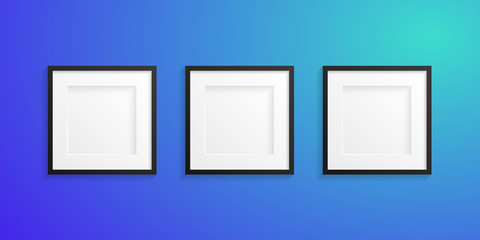 Front view of three realistic and modern white frames with black edge on a blue colored wall - Mock-up - Free space for designer