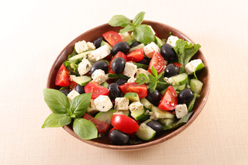 mixed salad with tomato, olive, feta cheese, basil and sauce