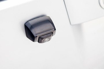 Fototapeta premium Close-up Interior view with rear view camera on the trunk of luxury very expensive new silver car in the vehicle repair workshop. Auto service industry. Safety drive.