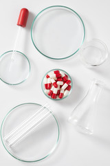 medicine capsule with laboratory equipment on white background for healthy cure