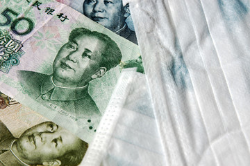 Coronavirus Wuhan illness concept. Chinese money and medical mask