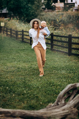 Happy family. Mother with son child playing having fun together on the grass in sunny summer day. Life moment