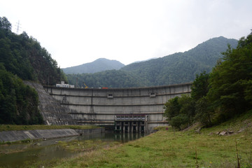 Fototapeta na wymiar Bradisor Dam is a large hydroelectric dam on the Lotru River situated in Romania.