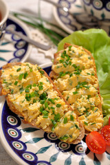 Scrambled eggs with chive on fresh crispy bread, homemade delish breakfast