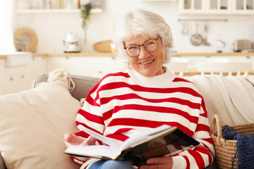 Leisure, self education, hobby and retirement concept. Picture of good looking mature senior female...
