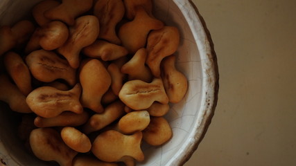 background image of a ceramic white plate with fish-shaped cookies