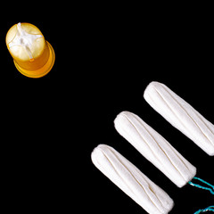 Woman health. Menstrual period concept. Woman hygiene protection. Cotton tampons on black background