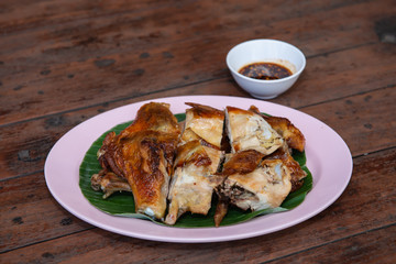 Chicken grill thai style with sauce on wood table