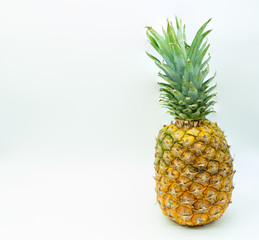 Isolated pineapple on a white background on the right with space on the left for text. Healthy food concept.