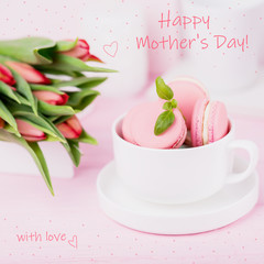 Happy Mother's Day concept. Inscription, text, words. Pink macaroons and spring tulips on pink background