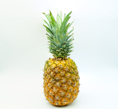 Isolated pineapple on a white background in the center of the image. Healthy food concept.