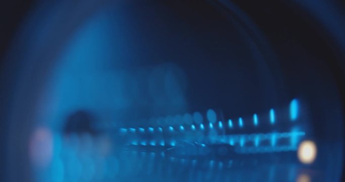 Close-up of a professional camera lens in a studio on a dark background. Professional Video or Photo Camera. Camcorder Lens. Adjusting Camera lens aperture. News. Copy Space. Graphics. Television. 4K.