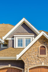 The roof of the house with nice window.