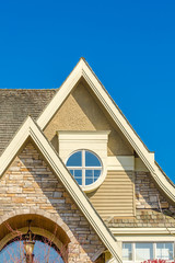 The roof of the house with nice window.