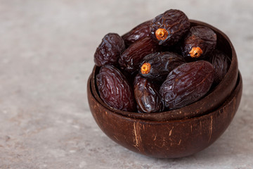Juicy organic Medjool dates  on a bright background