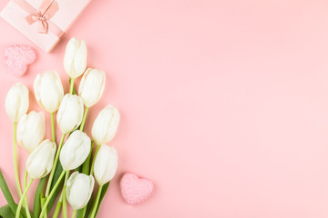 White tulip on pastel pink background. Traditional holiday gift.