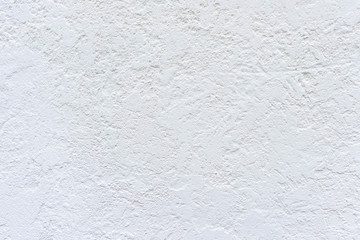 White painted plastered rough wall, white grained background