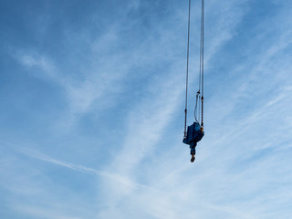 Obraz premium crane hook seen from below with blue sky background