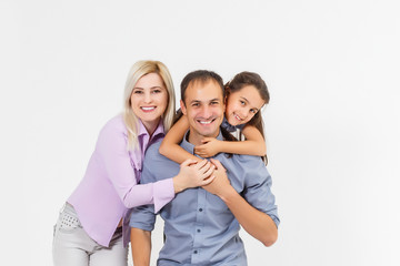 Happy young family with pretty child posing on white background