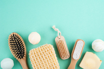Wooden natural spa objects on mint green background