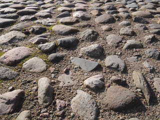 Old paving stones in perspective closeup, background, texture.
