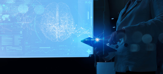 Female Doctor surgeon analyzing patient brain with human anatomy on technological digital tablet futuristic Ui and digital holographic innovative with science and medicine concept.
