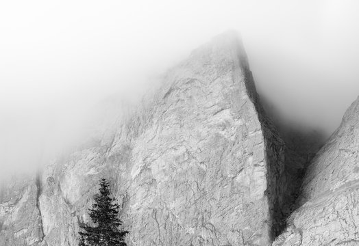 A detail of the Spigolo Abram of Piz Ciavazes mount in the Sella group wrapped in clouds, dolomites, Trentino Alto Adige, Italy, Europe