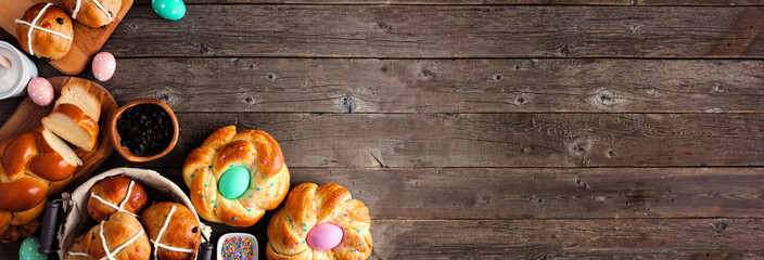 Easter table scene with a selection of fresh breads. Overhead view banner with corner border over a...