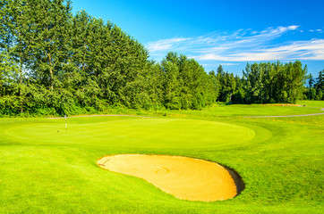 Golf course with gorgeous green and sand bunker