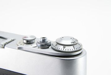 Old film retro camera. Shutter and trigger (button) close-up. Metallic black. White isolated background.