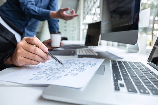 Professional Team of programmer working on project in software development computer in IT company office, Writing codes and data code website and coding database technologies on new Application