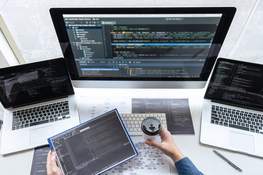 Developer programmer working on project in software development computer in IT company office, Writing codes and data code website and coding database technologies to find solution to problem