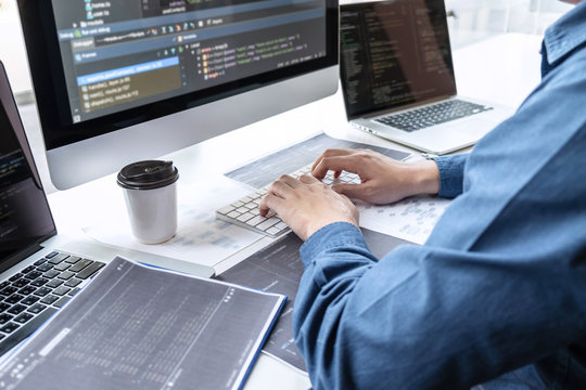 Developer programmer working on project in software development computer in IT company office, Writing codes and data code website and coding database technologies to find solution to problem