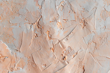 Texture of the wall with figured putty in coral color.