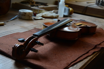 Detail of work table of luthier with old violin in Spain