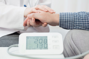 doctor measures the patient’s pressure and holds his hand, healthcare, hospital and medicine...