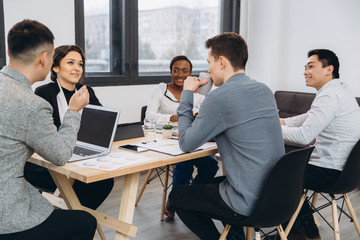 Group of multicultural businesspeople listening their boss speech - asian man manager talking to his team
